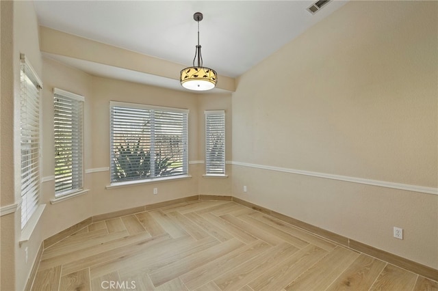 unfurnished dining area featuring parquet floors