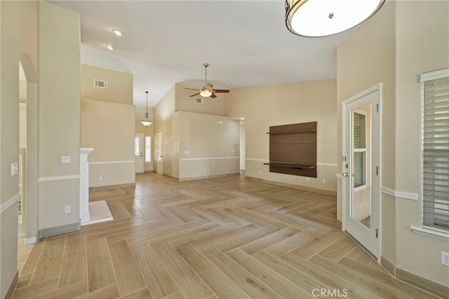 unfurnished living room with ceiling fan, high vaulted ceiling, and light parquet floors