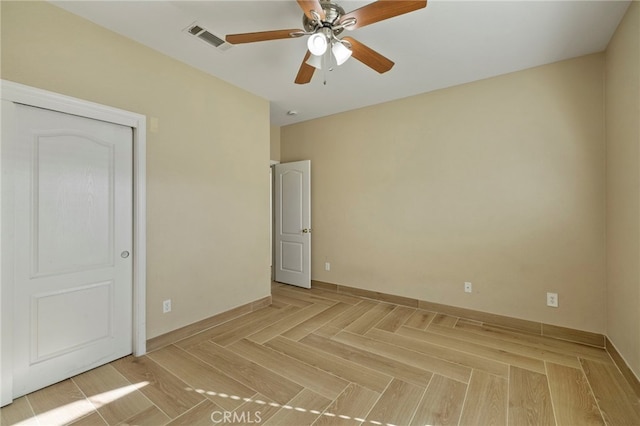 unfurnished bedroom with ceiling fan and a closet