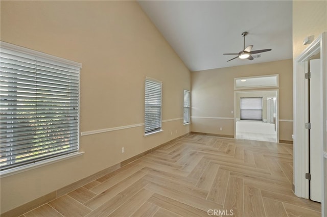 interior space with vaulted ceiling, ceiling fan, and light parquet floors