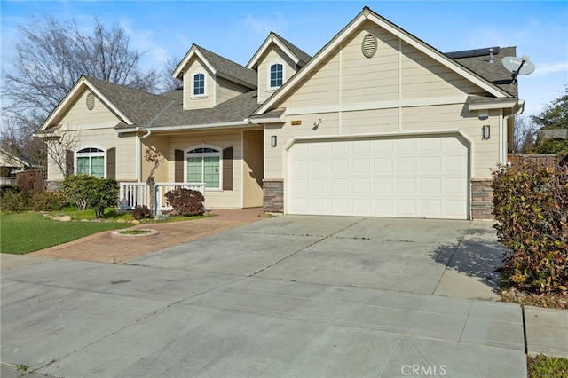 view of front of house with a garage and solar panels