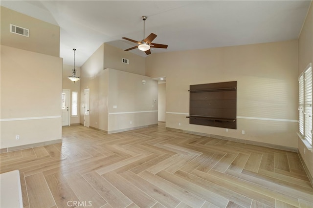 unfurnished living room featuring ceiling fan, parquet flooring, and high vaulted ceiling