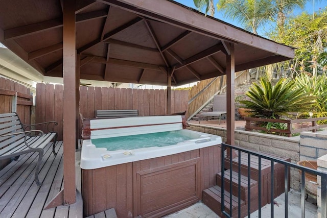 wooden deck featuring a gazebo and a hot tub