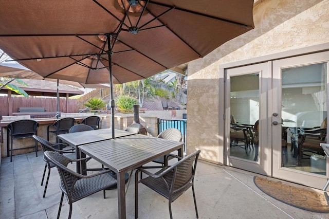 view of patio / terrace with a bar and french doors