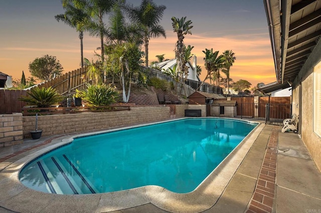 view of pool at dusk