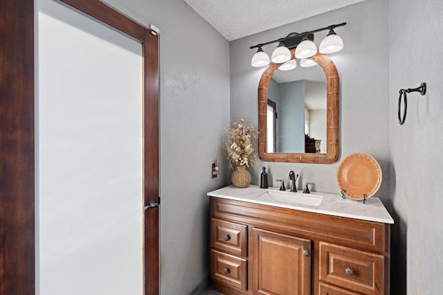 bathroom with vanity and a textured ceiling