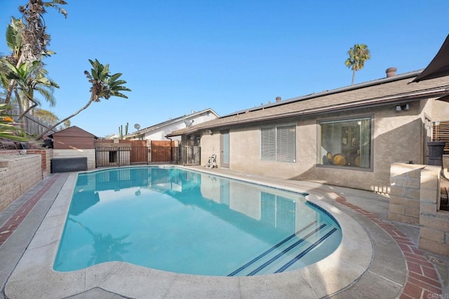 view of swimming pool featuring a fenced in pool, a fenced backyard, and a patio area