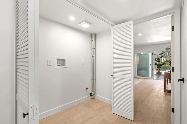 laundry area featuring washer hookup and light hardwood / wood-style flooring