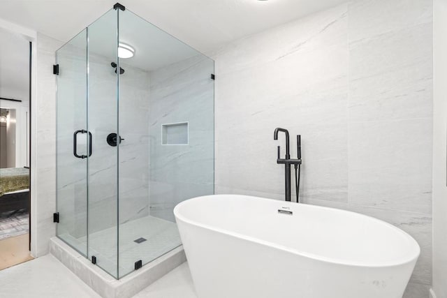 bathroom with tile walls and plus walk in shower