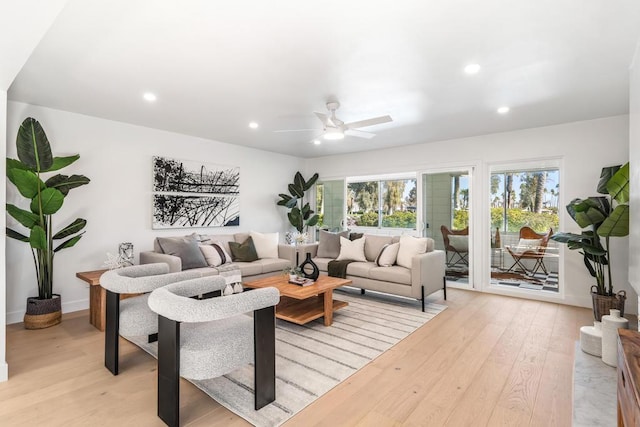 living room featuring ceiling fan and light hardwood / wood-style floors