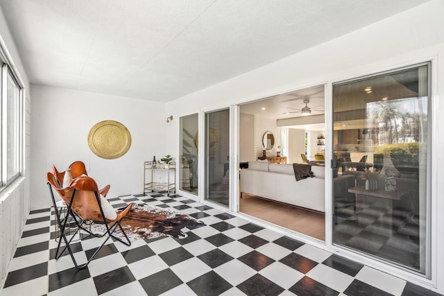 sunroom featuring ceiling fan