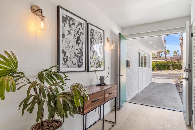 hall with light hardwood / wood-style flooring