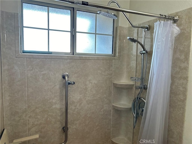 bathroom featuring plenty of natural light and curtained shower