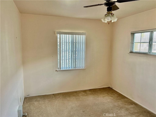 carpeted spare room featuring ceiling fan