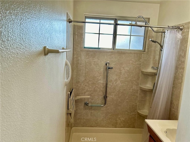 bathroom with curtained shower and vanity