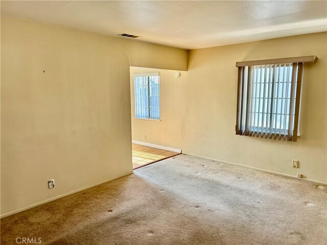 spare room with a healthy amount of sunlight and carpet floors