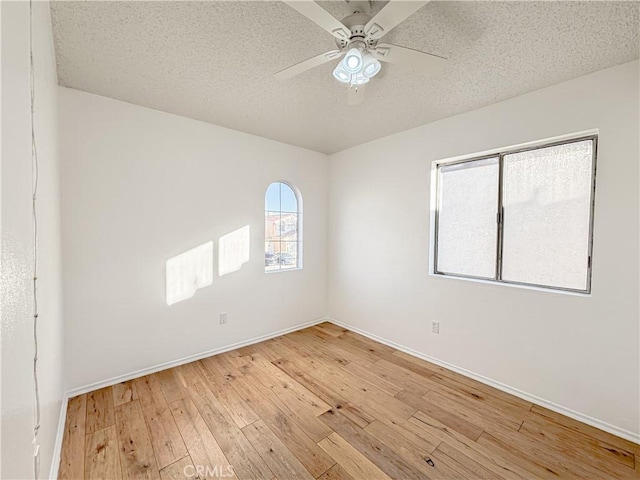 unfurnished room featuring wood-type flooring, ceiling fan, and a textured ceiling