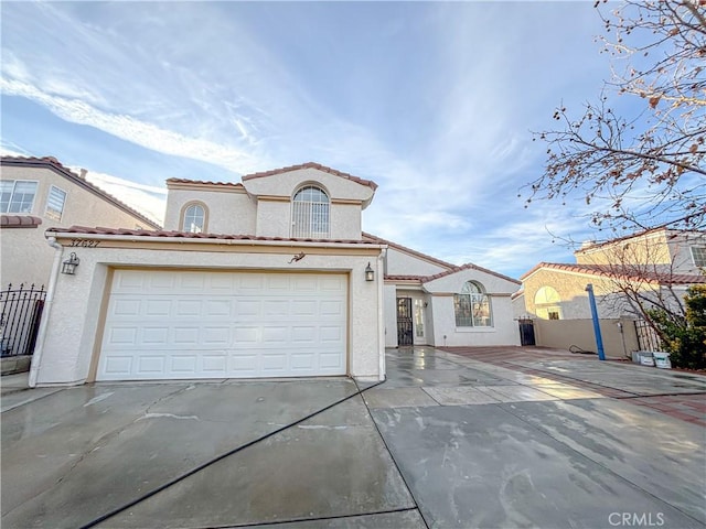 mediterranean / spanish house with a garage