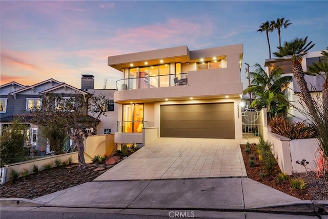 contemporary house with a balcony and a garage