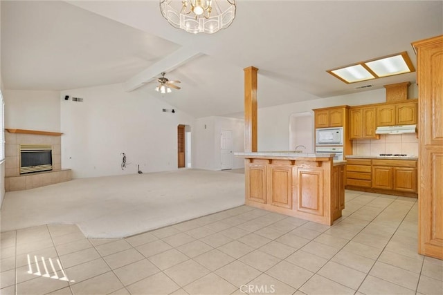 kitchen with backsplash, a fireplace, a center island with sink, vaulted ceiling with beams, and white appliances