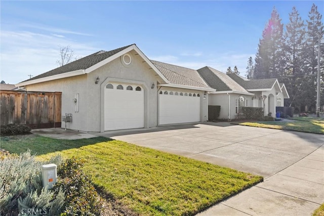 view of front of property with a garage and a front yard