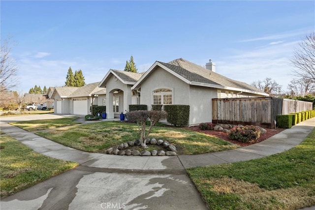 view of front of house with a garage and a front yard