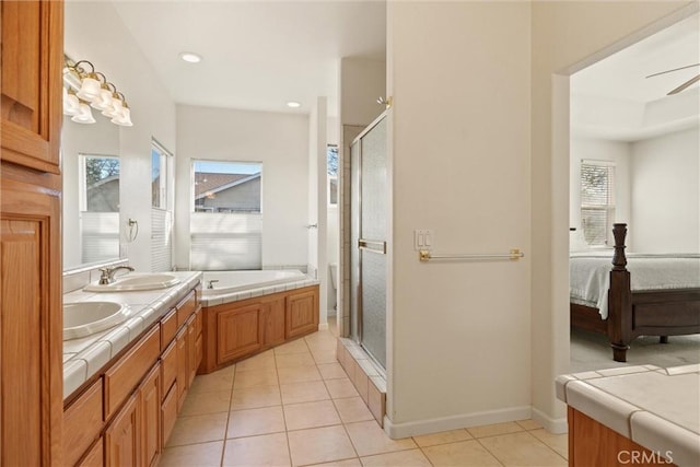 bathroom featuring ceiling fan, shower with separate bathtub, vanity, and tile patterned flooring