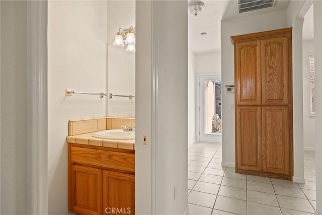 bathroom with tile patterned floors and vanity