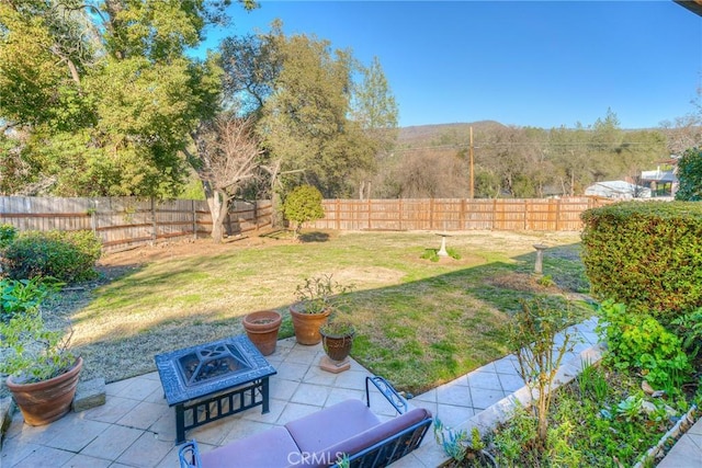 view of yard with an outdoor fire pit and a patio