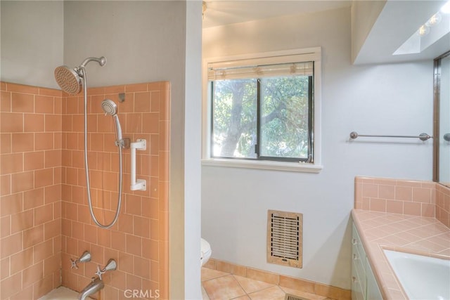 bathroom featuring toilet, heating unit, tile patterned floors, and vanity