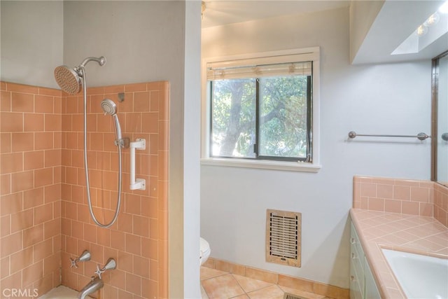 bathroom featuring toilet, tile patterned floors, vanity, baseboards, and heating unit