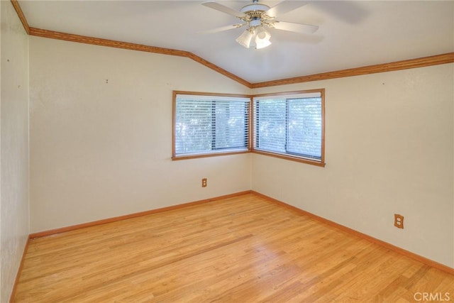 spare room with lofted ceiling, light wood-type flooring, a ceiling fan, and baseboards