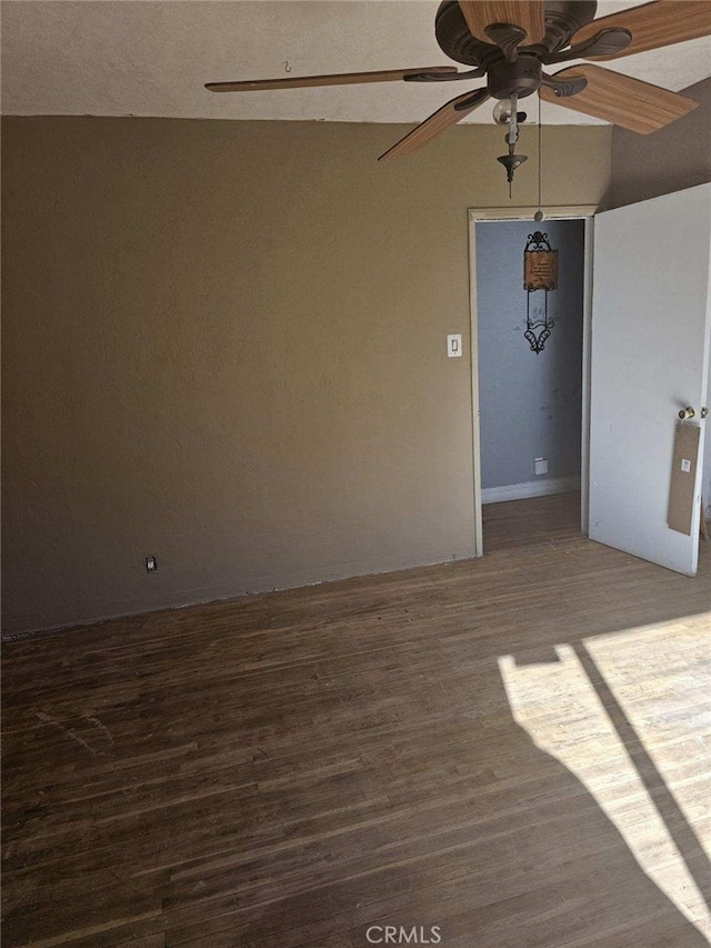 unfurnished room featuring a ceiling fan and wood finished floors