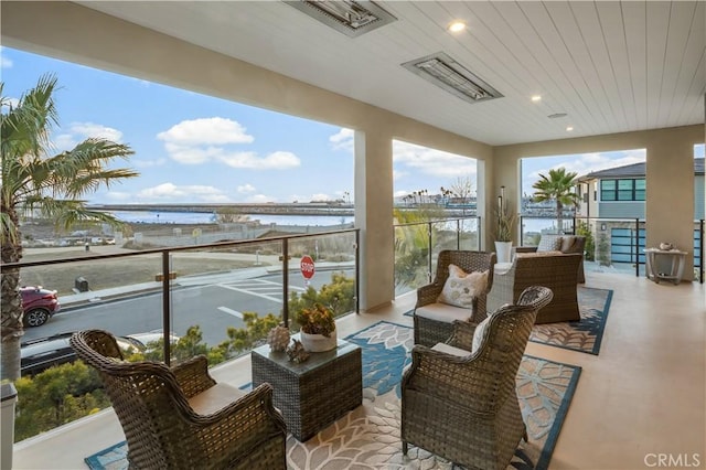 balcony featuring a water view and outdoor lounge area