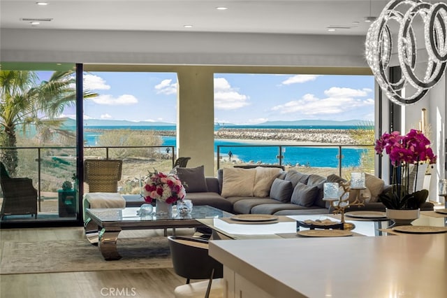 living room with a water view and wood-type flooring