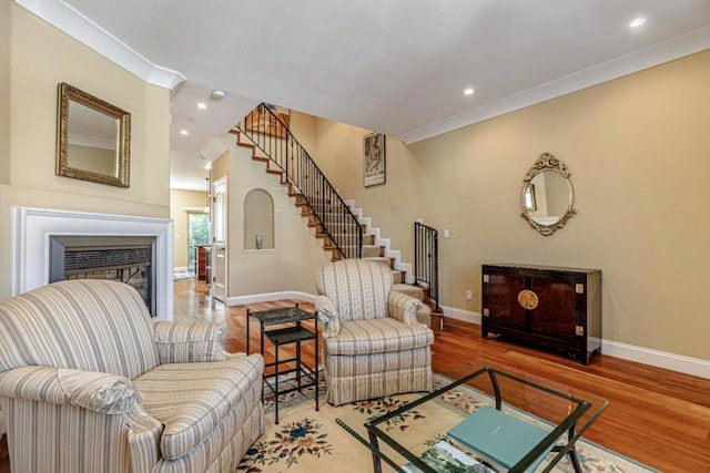 living room with ornamental molding and hardwood / wood-style flooring