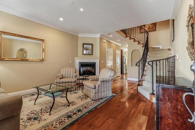 living room featuring ornamental molding and wood-type flooring