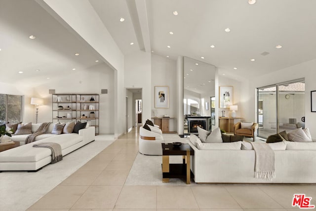 living room featuring light tile patterned floors and a towering ceiling