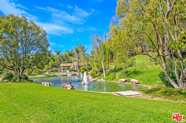 view of home's community featuring a yard and a water view