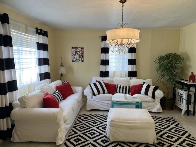 living room with light tile patterned floors and a notable chandelier