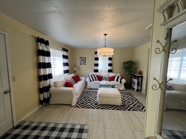 living room featuring a textured ceiling and a notable chandelier