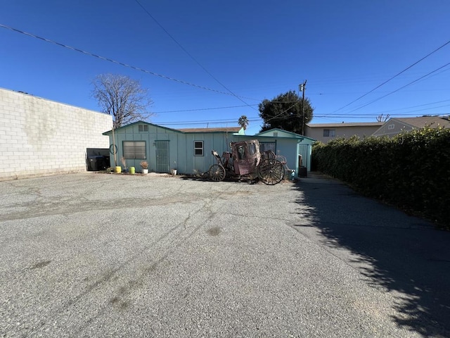 exterior space with a garage and an outbuilding