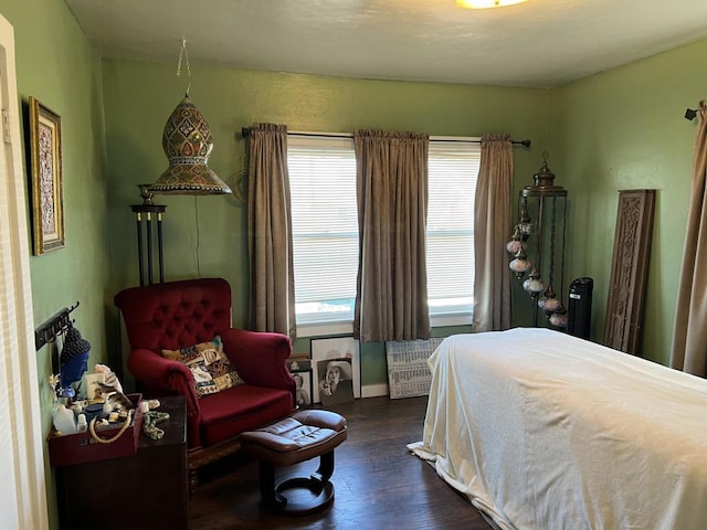 bedroom with dark wood-type flooring