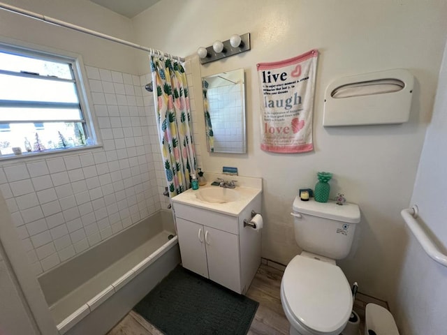 full bathroom featuring vanity, hardwood / wood-style floors, shower / tub combo, and toilet