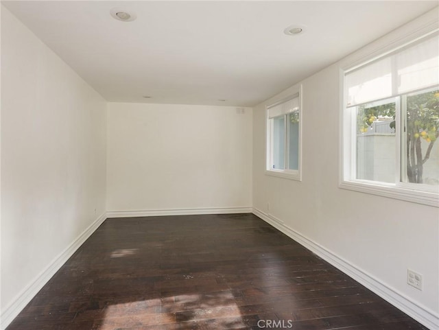 empty room with dark hardwood / wood-style floors