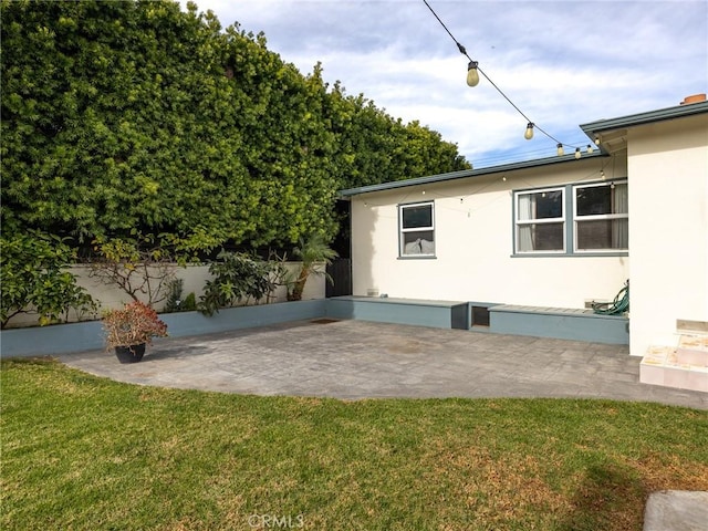 exterior space featuring a yard and a patio area