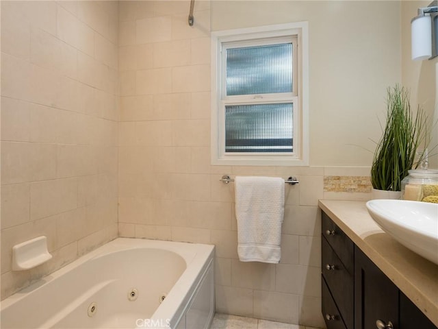 bathroom with tile walls, vanity, and a bathtub