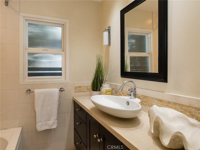 bathroom with tile walls and vanity