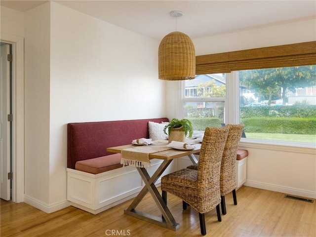 dining area with wood-type flooring and breakfast area