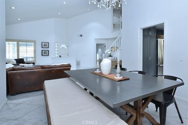 dining room with high vaulted ceiling and a notable chandelier